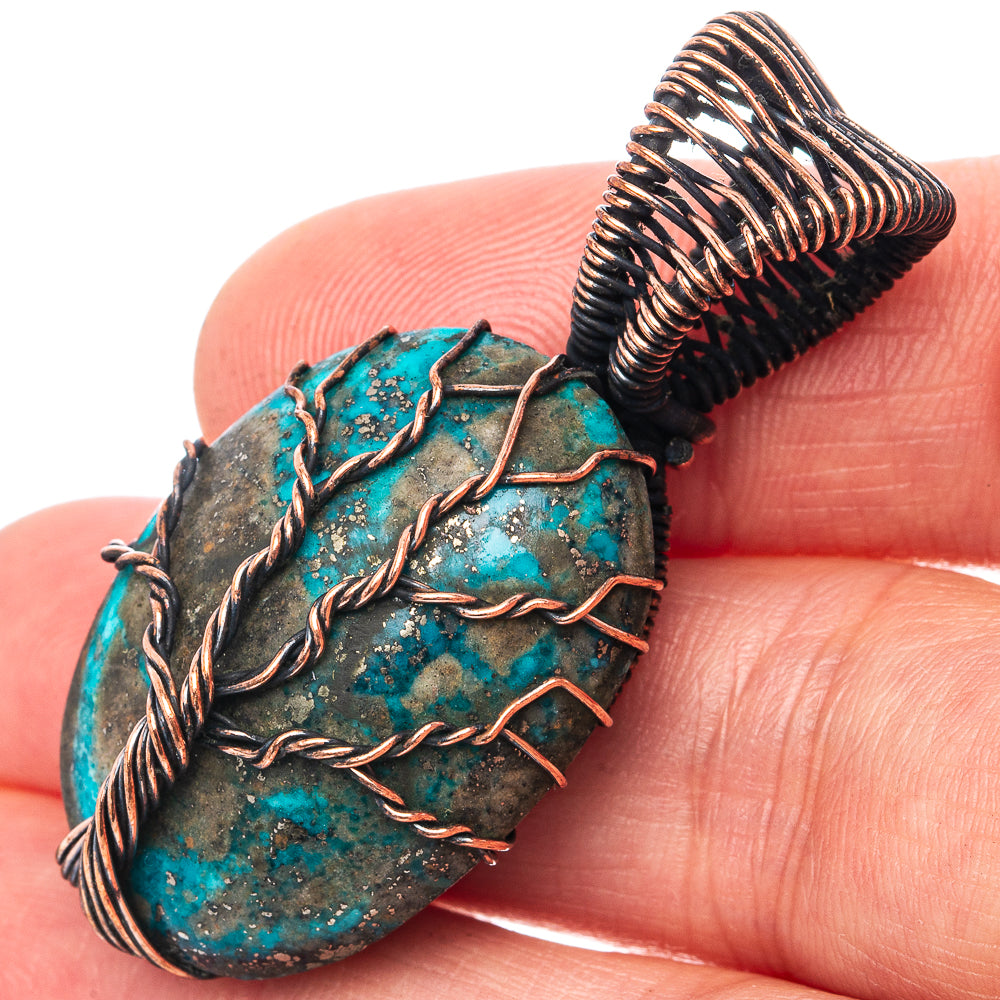 Turquoise tree-of-life pendant with oxidized copper wire wrap, round stone face