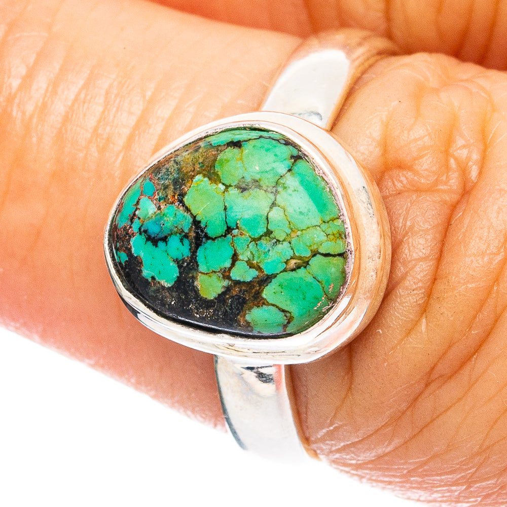 Turquoise spiderweb cabochon sterling silver ring on hand, oval bezel, size 6.75