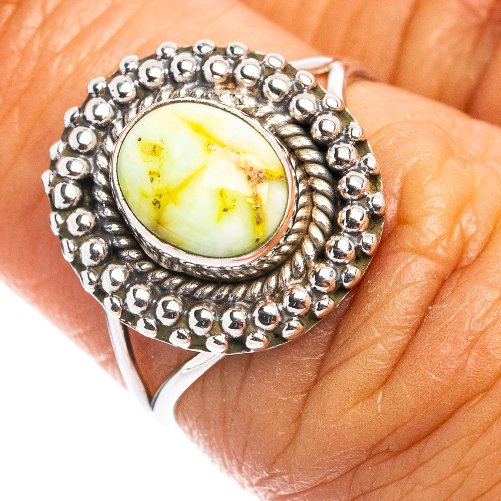 Sterling silver dainty ring with oval yellow-green turquoise cabochon and beaded bezel