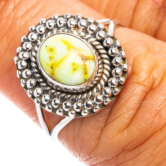 Sterling silver dainty ring with oval yellow-green turquoise cabochon and beaded bezel