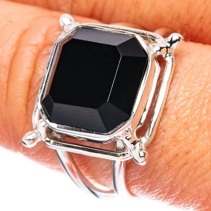 Sterling silver ring with faceted dark gemstone in octagonal bezel setting