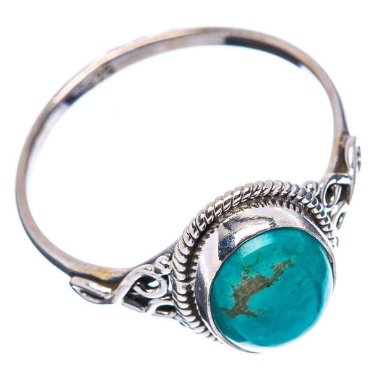 Sterling silver ring featuring round-edged turquoise cabochon and pierced metalwork sides