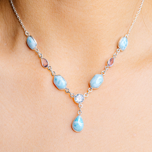 Sterling silver gemstone pendant necklace with oval light-blue stones and teardrop center
