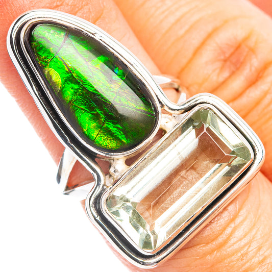 Sterling silver ring with oval green ammolite centerpiece and clear rectangular stone