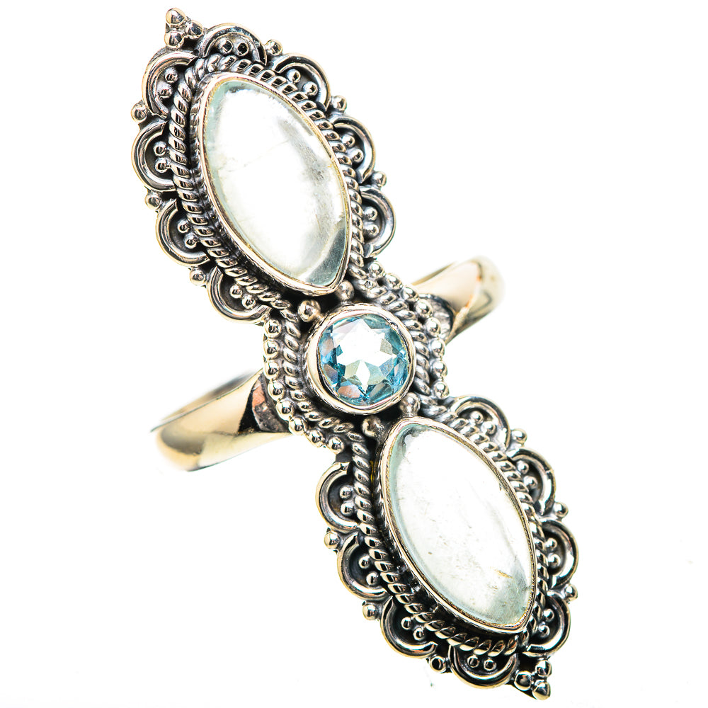 Sterling silver ring with oval opalescent settings and a small blue gemstone center