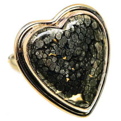 Heart-shaped black gemstone ring with gold flecks, openwork metal border on band