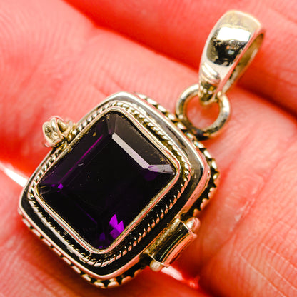 Faceted amethyst pendant in silver bezel setting with decorative frame and bail