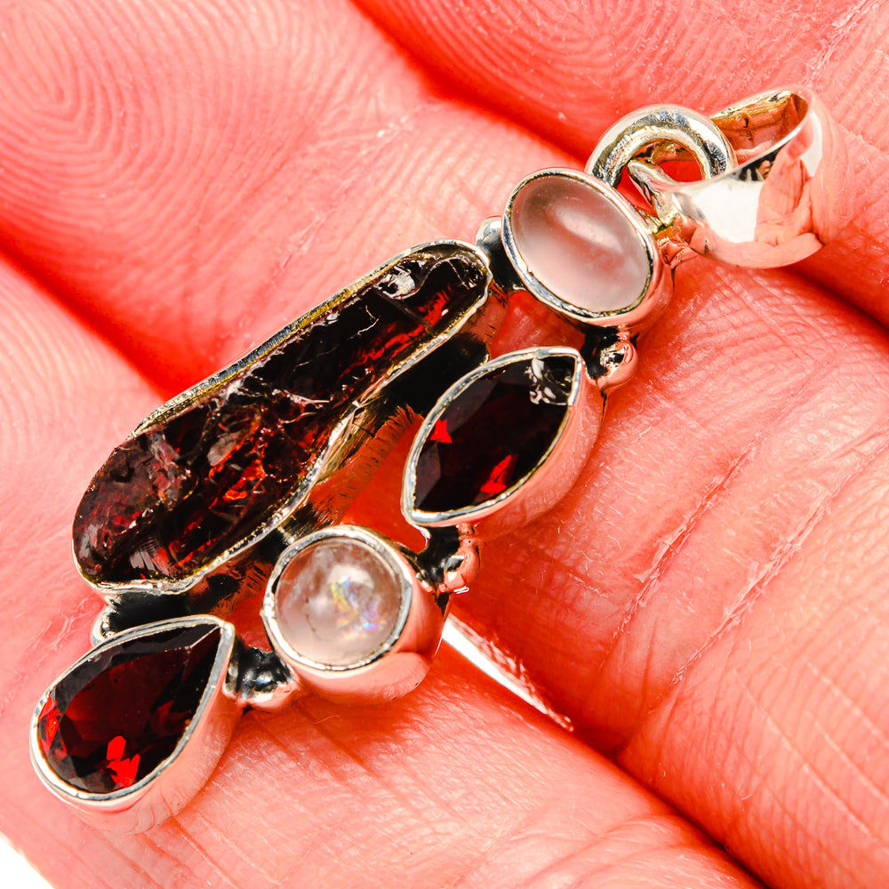 Close-up silver pendant with rough red garnet facets and pale pink cabochon ovals