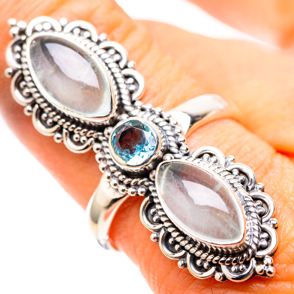 Silver filigree ring with two large oval opalescent stones and a blue round gemstone