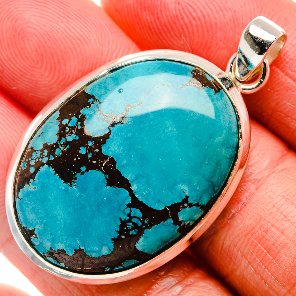 Oval turquoise pendant with silver bezel and bail, featuring natural web pattern