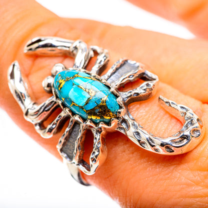 Silver-tone turquoise cabochon ring with ornate openwork band and bold oval setting