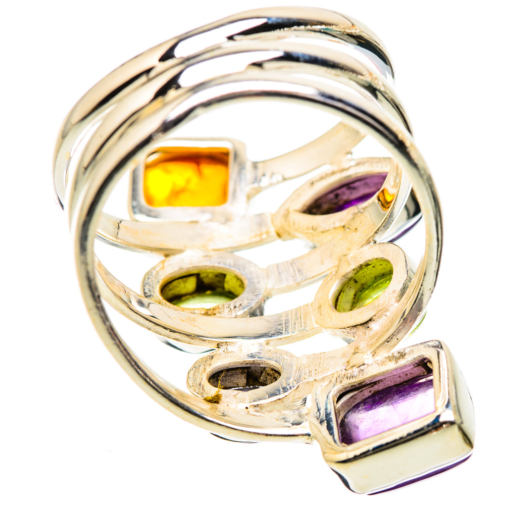 Silver gemstone ring close-up, mixed-cut purple, green, and orange stones in prongs