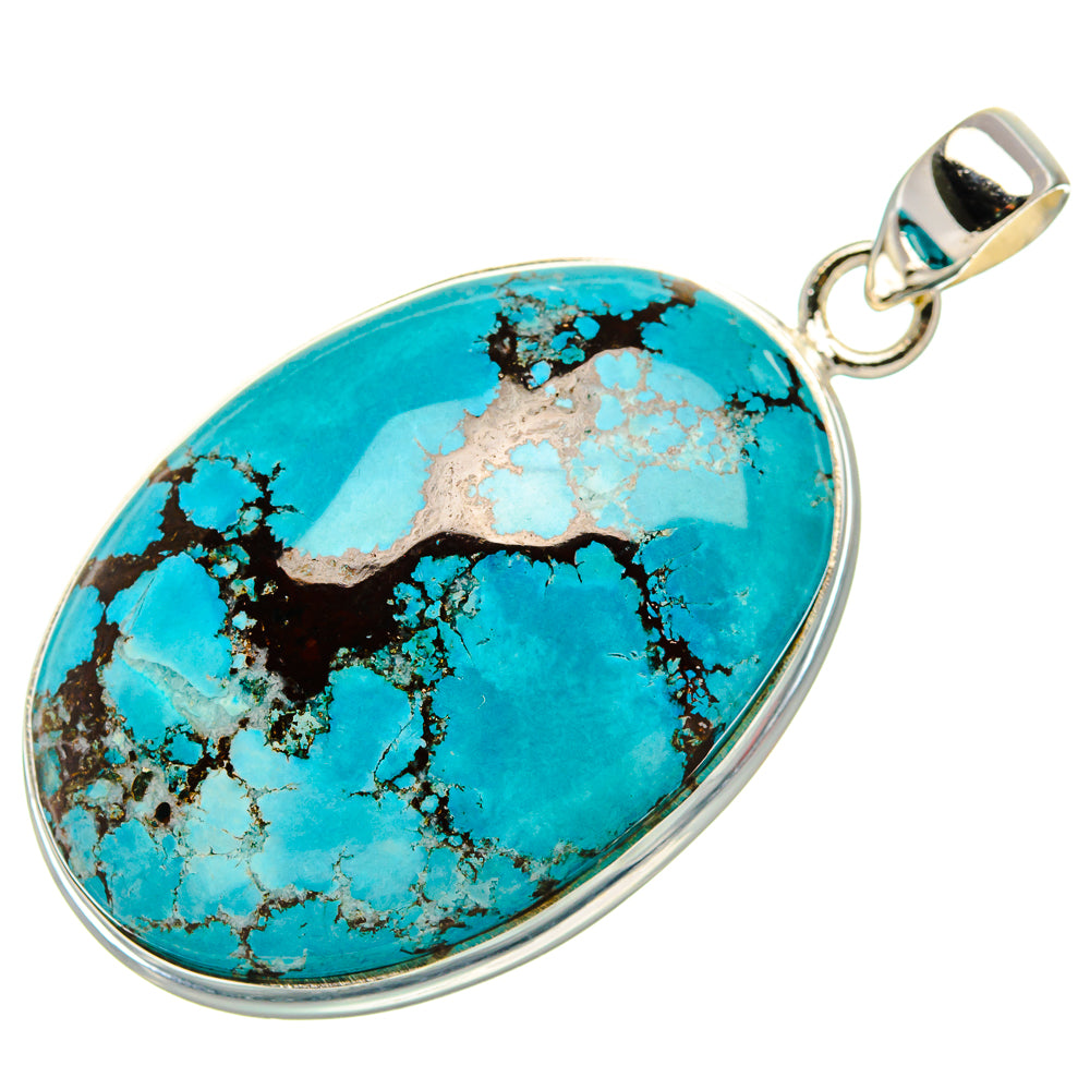 Oval turquoise pendant with black web matrix, silver frame and hanging bail