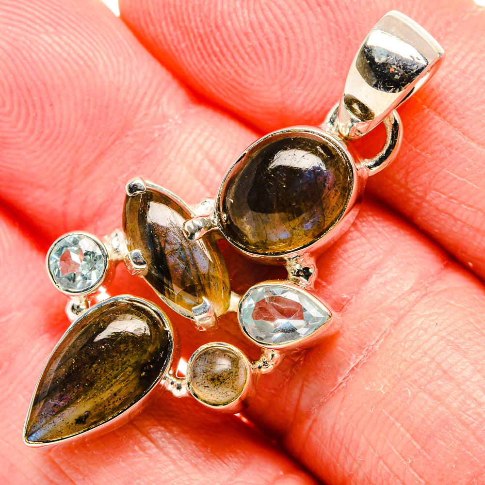 Sterling silver pendant with dark labradorite oval and blue topaz stones