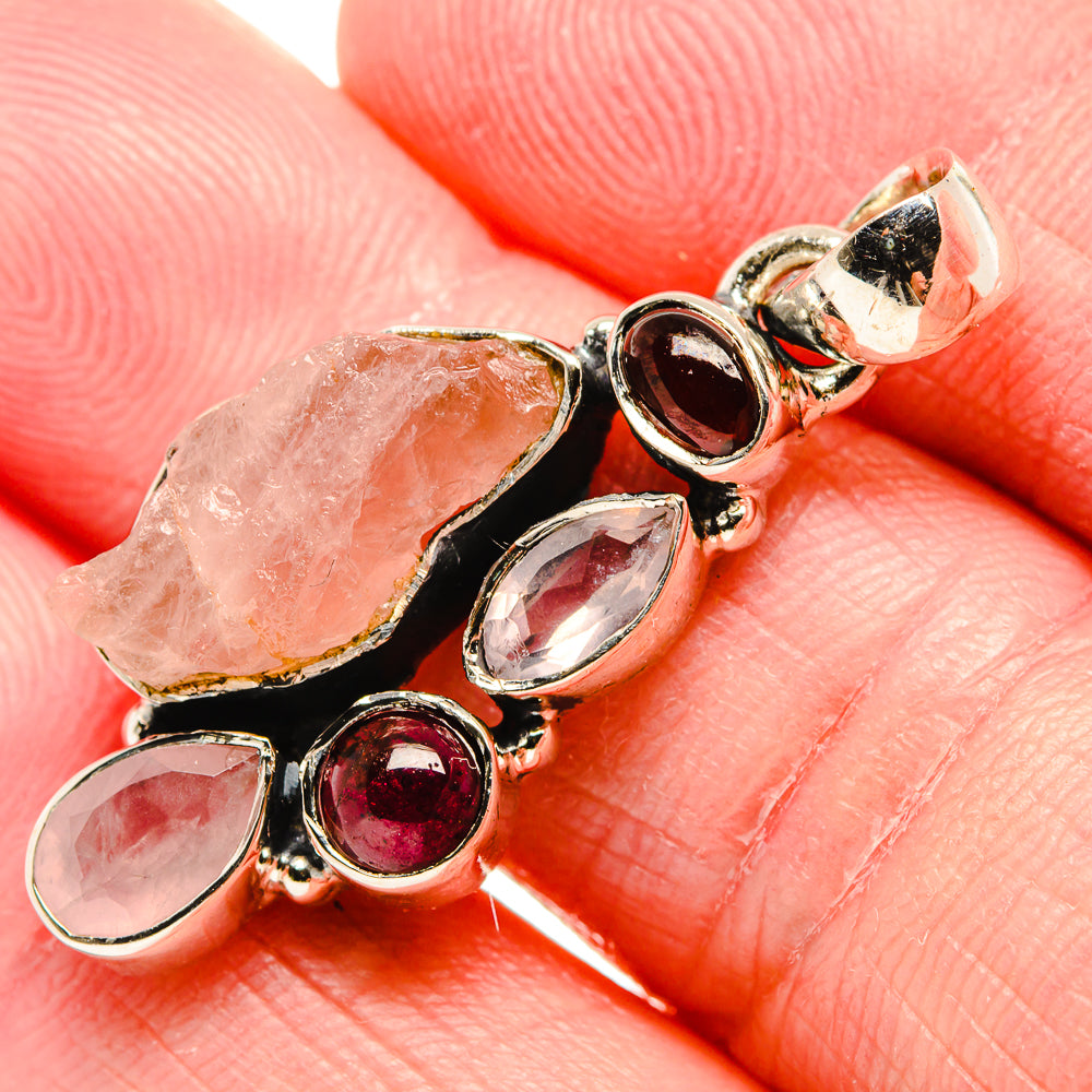 Sterling silver pendant close-up with rough rose quartz and marquise garnet stones