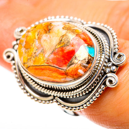 Sterling silver oval gemstone ring with turquoise accents and swirling orange/yellow stone