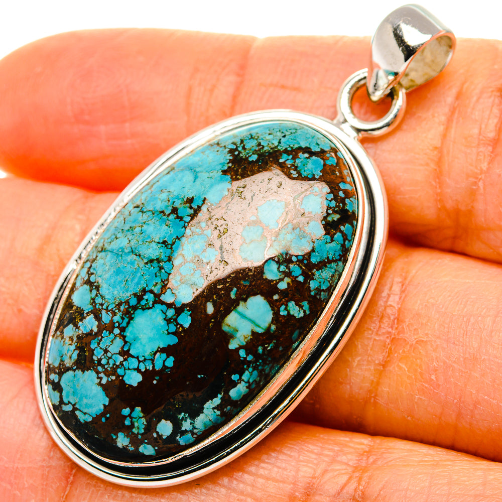 Oval turquoise gemstone pendant in sterling silver bezel with bail loop