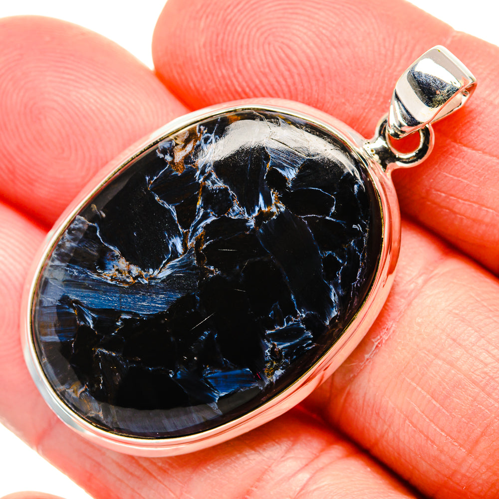Pietersite pendant in oval bezel with sterling silver bail, dark black and blue stone