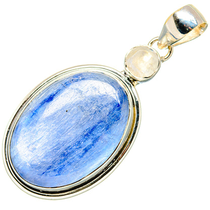 Sterling silver oval pendant with blue cabochon, round pale stones, and top bail