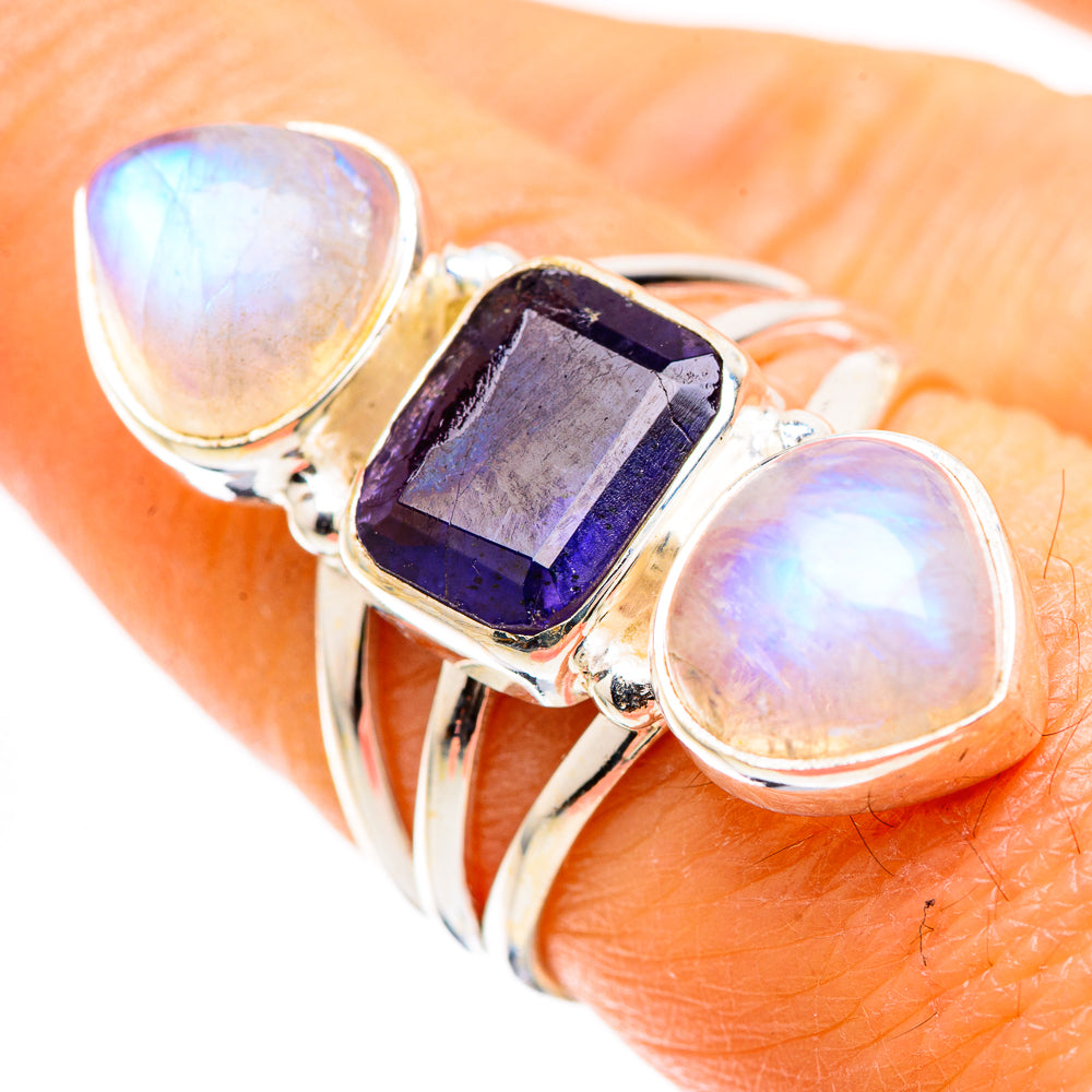 Silver ring with faceted dark blue square center and two opalescent oval moonstone stones