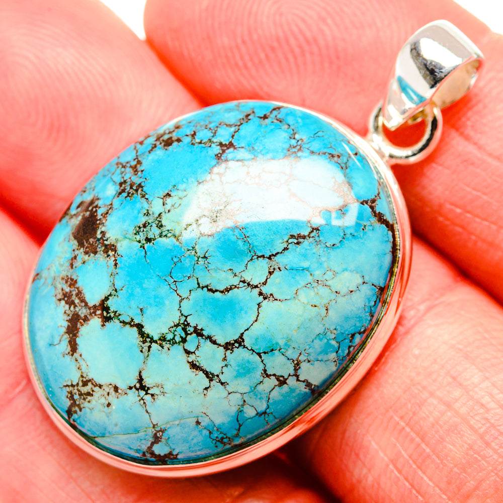 Oval turquoise cabochon with webbed matrix, 925 sterling silver bezel and loop bail