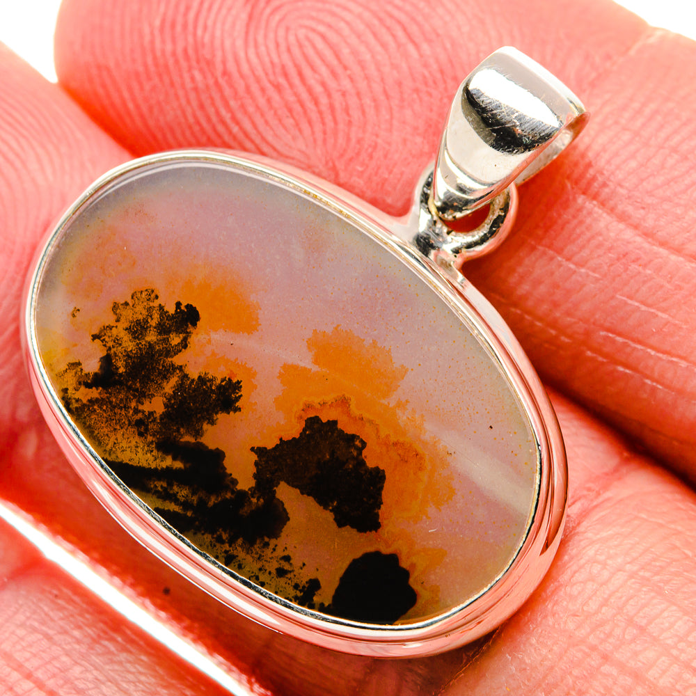 Oval sterling silver pendant with amber agate cabochon and black dendritic inclusions