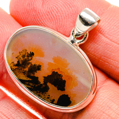 Oval sterling silver pendant with amber agate cabochon and black dendritic inclusions
