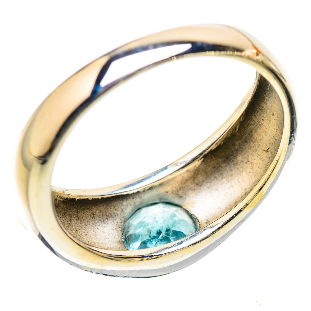 Sterling silver ring with blue gemstone detail, curved band interior and setting