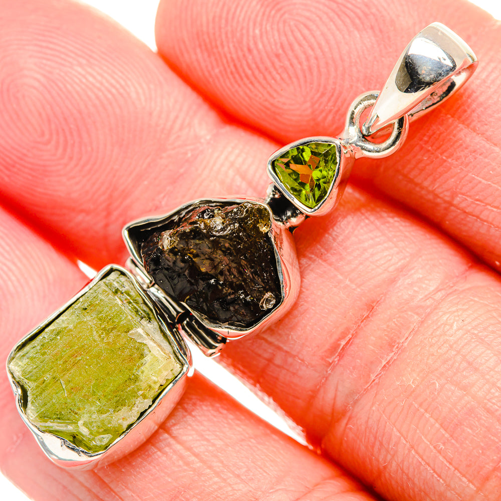925 sterling silver rough peridot pendant with three rough stones: two green, one dark.