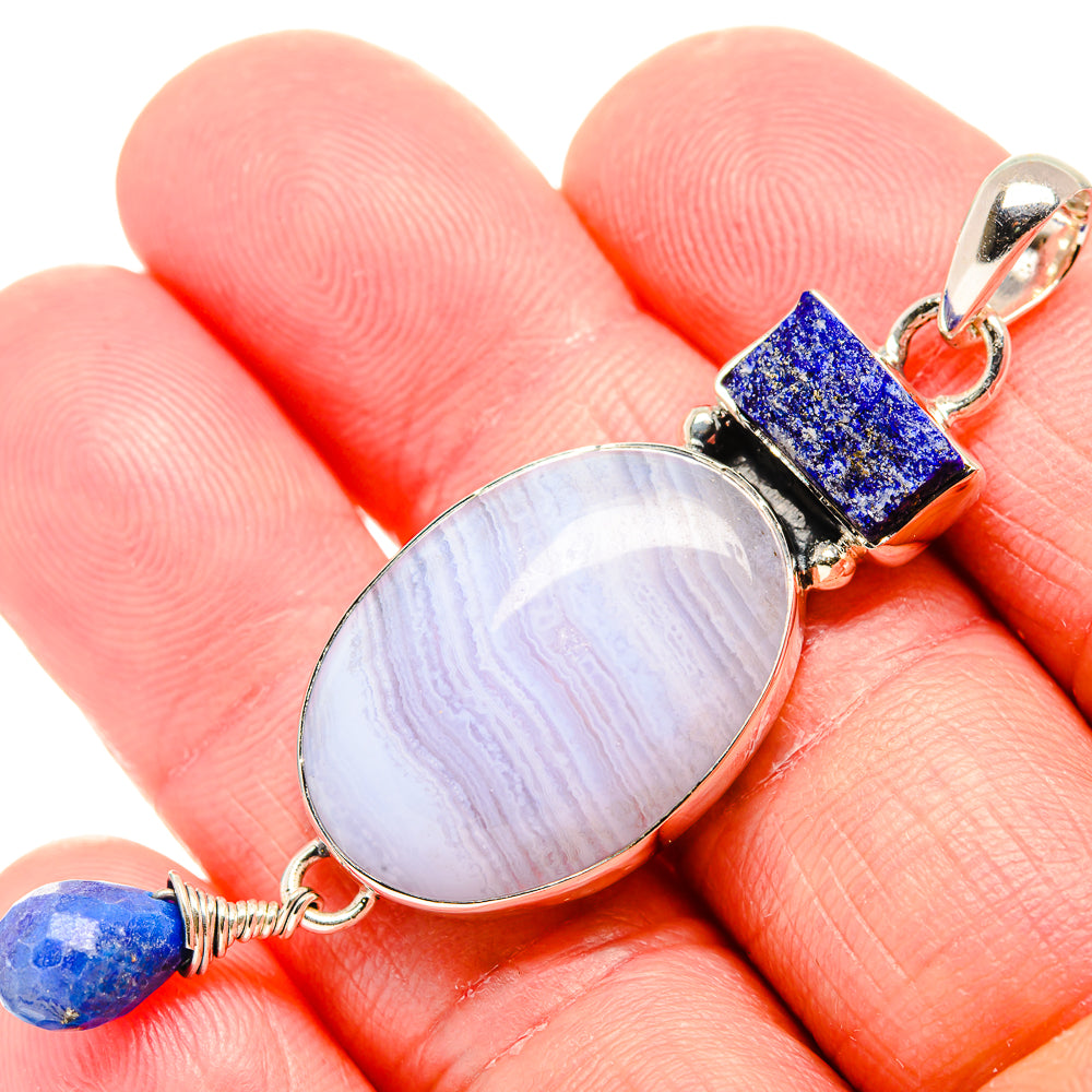 Oval blue lace agate pendant with lapis bead in sterling silver setting, close view