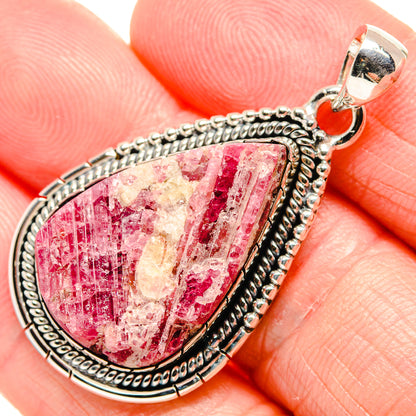 Rough red and pink gemstone teardrop pendant in textured sterling silver bezel
