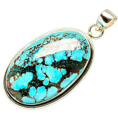 Oval turquoise cabochon pendant in silver bezel with top bail, blue and black