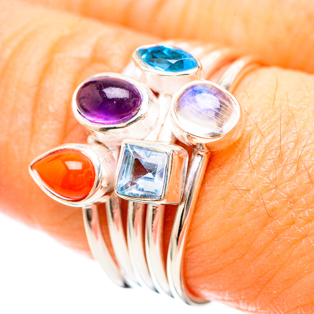 Sterling silver ring with orange, purple, and blue stones plus a clear square and round gem