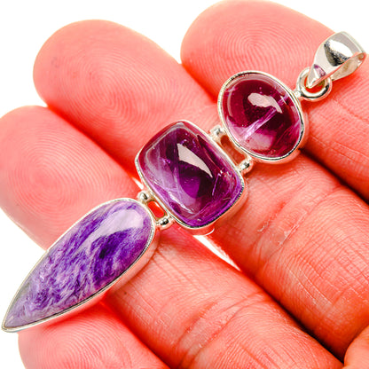Amethyst pendant close-up on hand; three purple stones in silver prong bezels