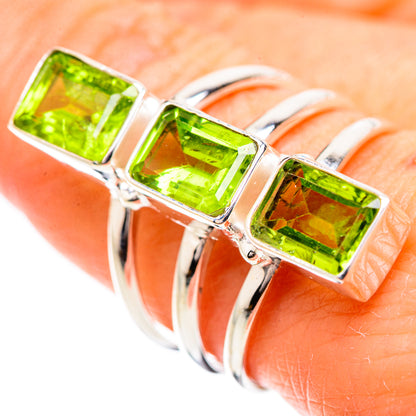 Sterling silver ring with three square green peridot stones in prong settings