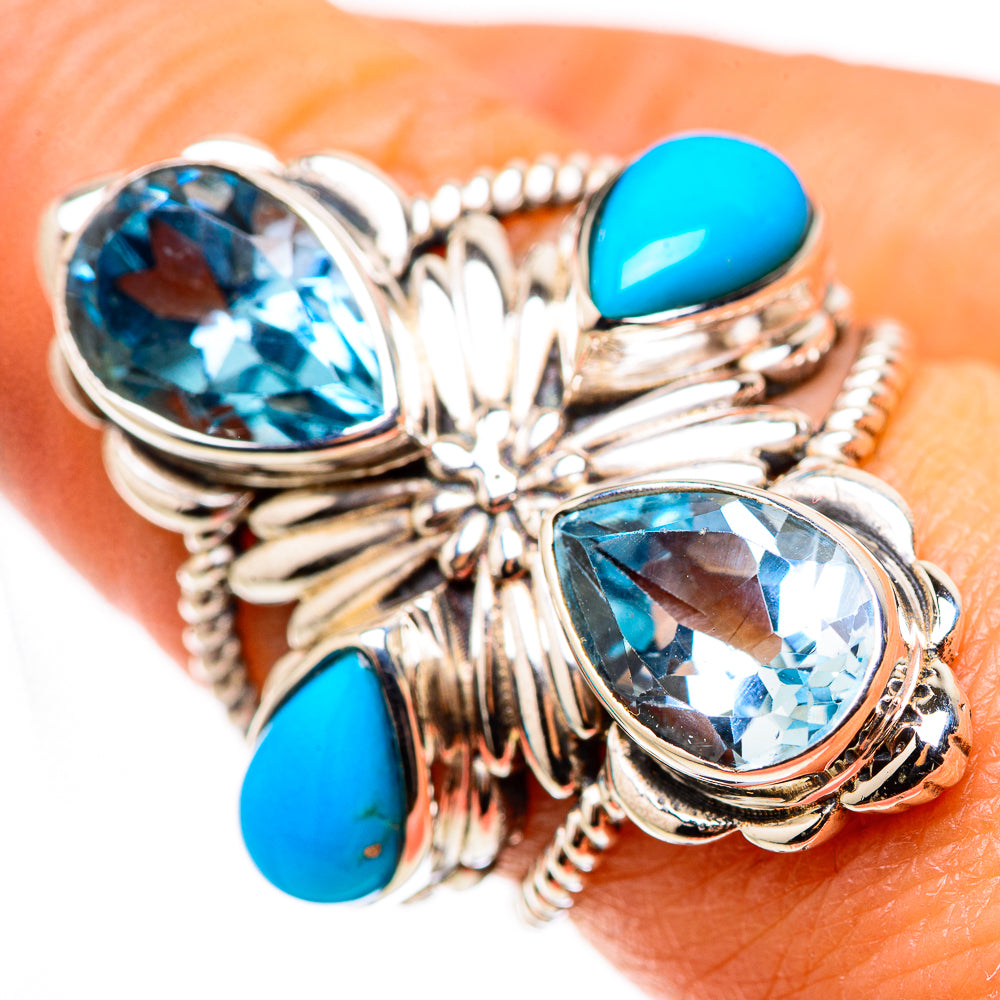 Silver turquoise ring with two oval blue stones and three turquoise cabochons on finger