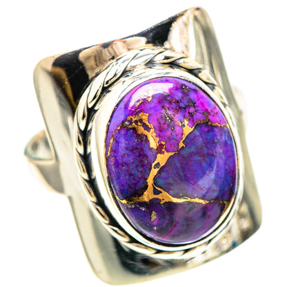 Sterling silver ring featuring oval purple gemstone with gold-toned matrix and ornate shoulders.
