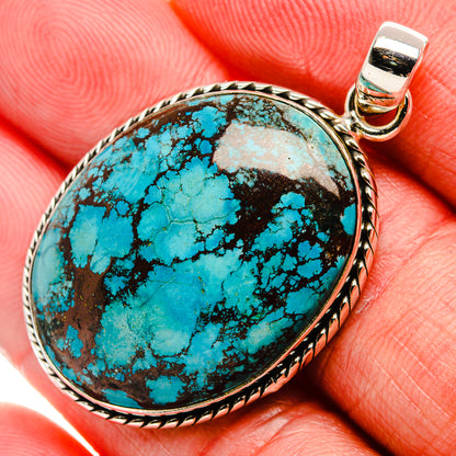 Tibetan turquoise oval pendant with black matrix cabochon and silver bezel, loop bail