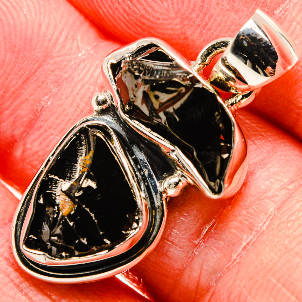 Close-up rough shungite teardrop pendant, polished 925 sterling silver frame