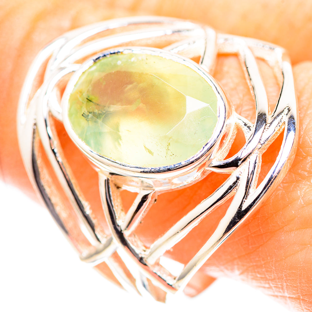 Sterling silver oval prehnite ring with high prong bezel and curved decorative bands