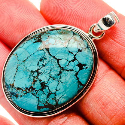 Oval turquoise gemstone pendant in 925 sterling silver bezel with bail, close-up