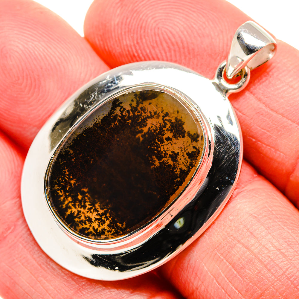 Oval dark amber dendritic agate pendant in polished sterling silver bezel with bail