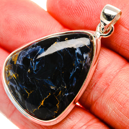 Close-up sterling silver pietersite pendant bail over black-blue teardrop stone with gold veins