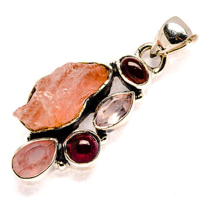 Sterling silver pendant with rough rose quartz stones and red garnet teardrop accents