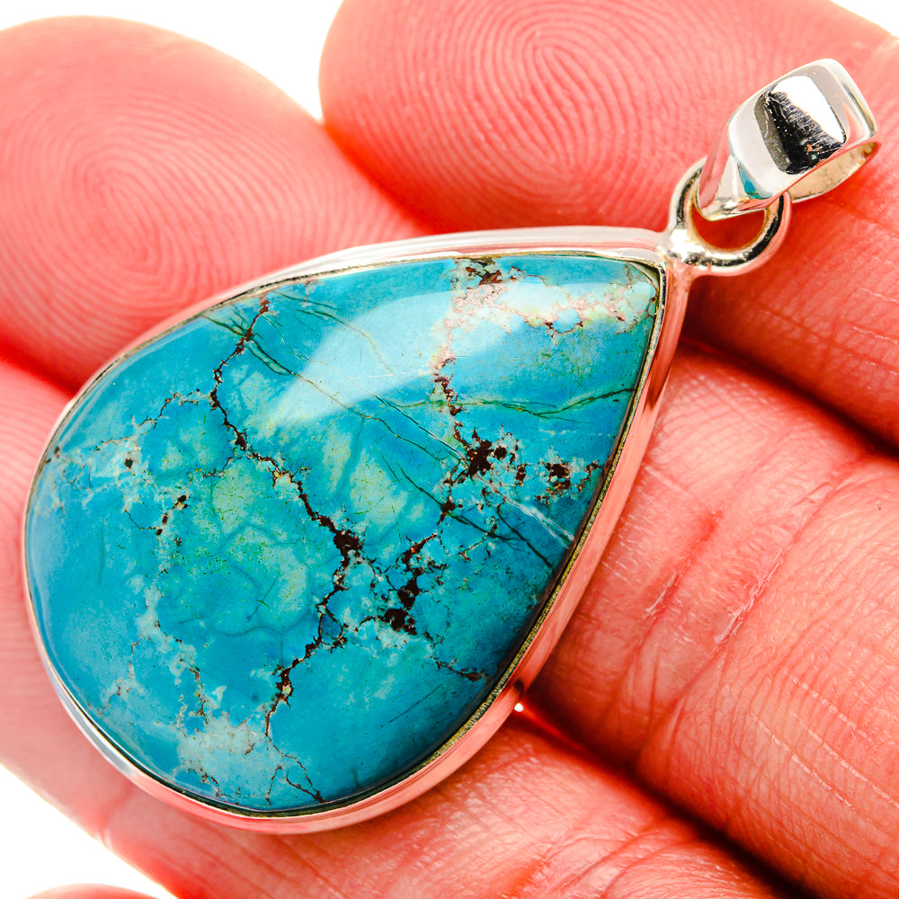 Teardrop turquoise pendant with sterling silver border and small loop bail.