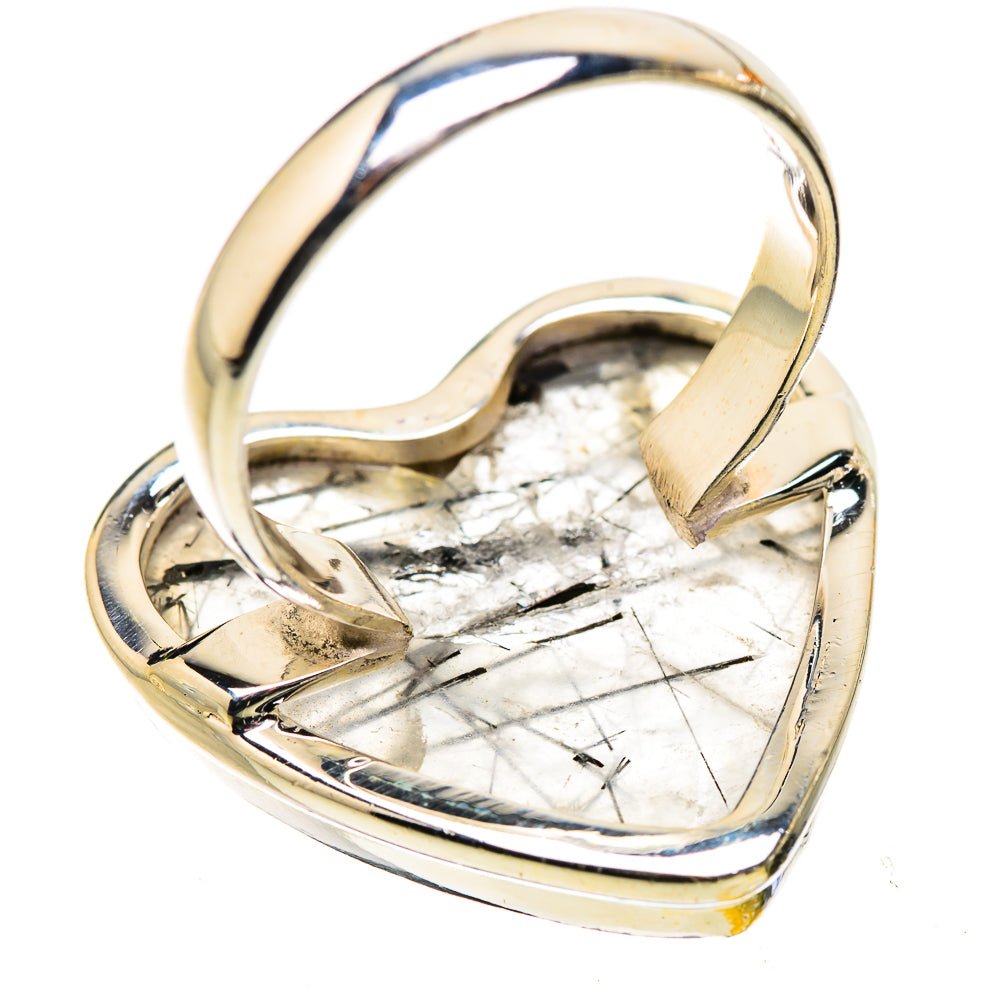 Heart-shaped sterling silver ring with clear quartz cabochon and dark inclusions, side profile