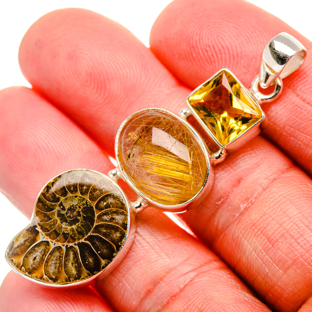 Ammonite fossil and faceted yellow citrine with round rutilated quartz in silver pendant