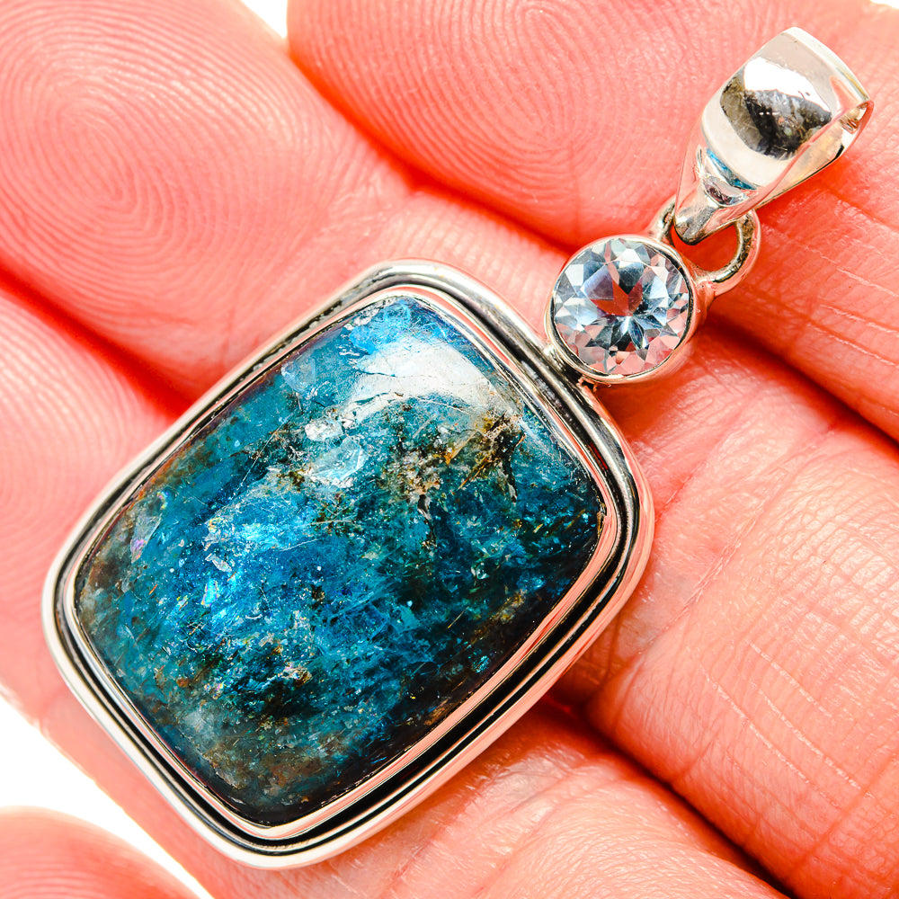 Sterling silver pendant with oval turquoise-blue stone and round blue topaz bail