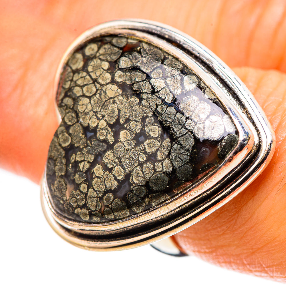 Heart-shaped black gemstone ring with gold-speckled texture and polished silver bezel