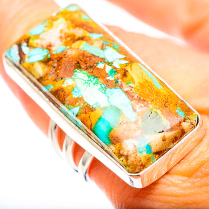 Turquoise and brown stone inlay rectangular ring on finger, sterling silver band